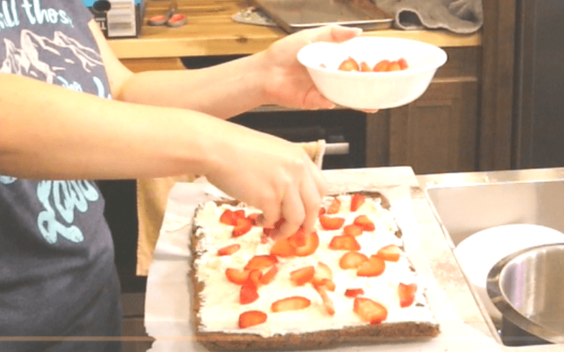 Adding Fresh Strawberries to the roll cake