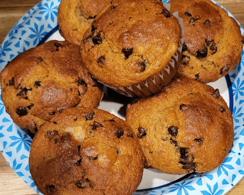 a plate of banana chocolate chip muffins