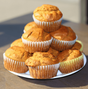 Pumpkin spice muffins made with fresh milled flour stacked on a plate