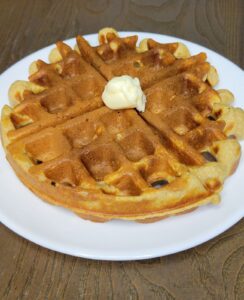 a Fresh milled flour Belgian waffle with a pad of butter