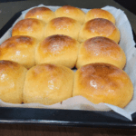 A tray of baked whole wheat Hawaiian sweet rolls