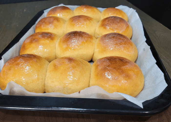 A tray of baked whole wheat Hawaiian sweet rolls
