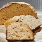 Fresh Milled Flour Sourdough bread sliced up with half the boule behind the slices