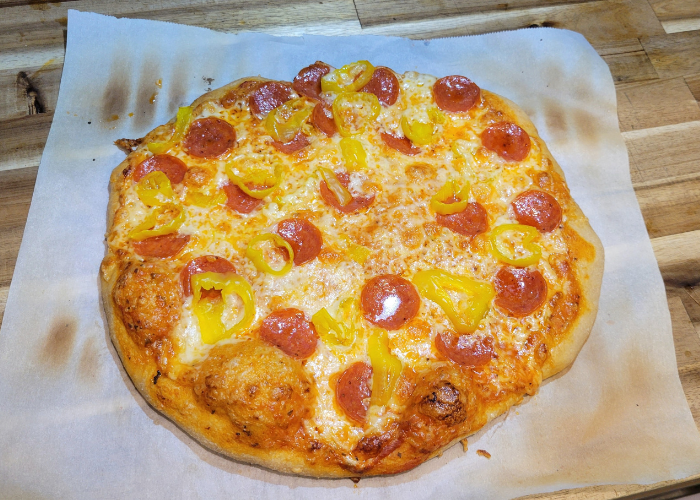 a photo of a pepperoni & banana pepper homemade pizza baked with bubbly crust, dough made with fresh milled flour