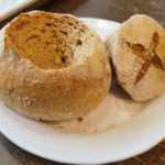 carved sourdough bread bowl with top waiting for soup