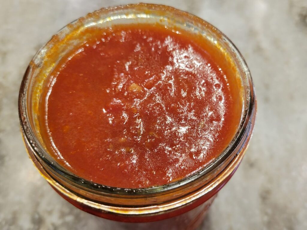 open jar of marinara sauce showing from the top