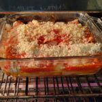 unbaked homemade manicotti with marinara sauce from scratch