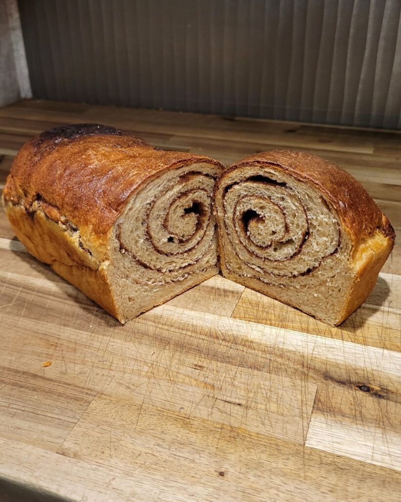 Fresh Milled Flour Cinnamon Swirl Bread Loaf cut in half showing the beautiful swirl