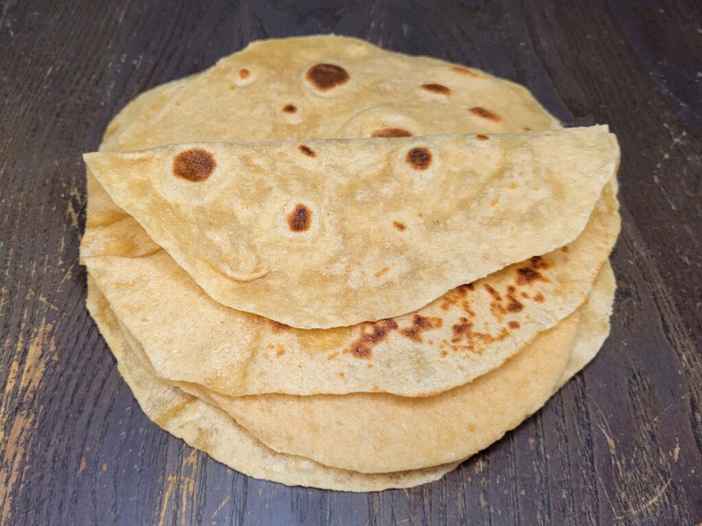 a tack of soft and foldable tortillas made with fresh milled flour