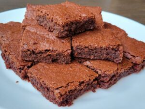 a plate full of a stack of sliced fresh milled flour brownies