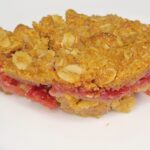 Fresh milled flour Raspberry crumble bar square on a white plate