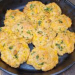 a cast iron skillet full of fresh milled flour easy garlic cheddar cheese drop biscuits