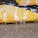 a Apple Turnover Made With Fresh milled flour ruff puff pastry drizzled with homemade icing.