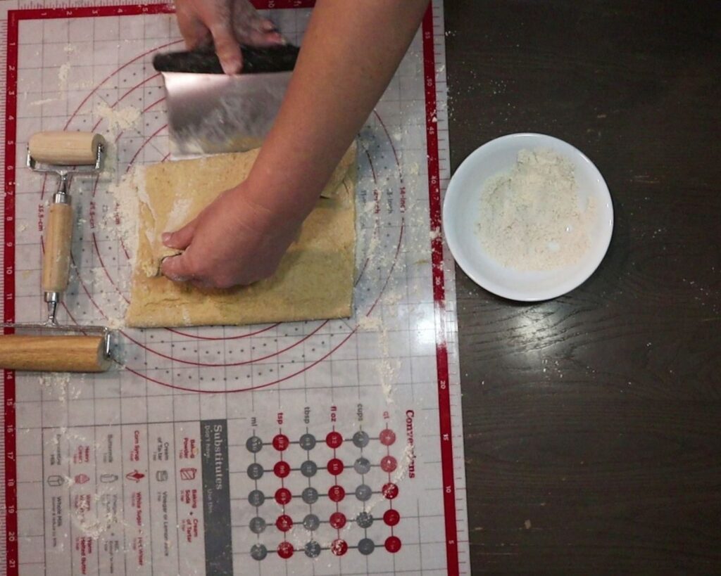 hand folding bottom of dough up