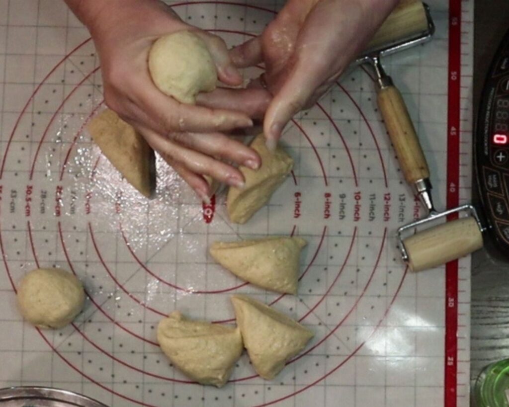 hands rolling the dough into balls