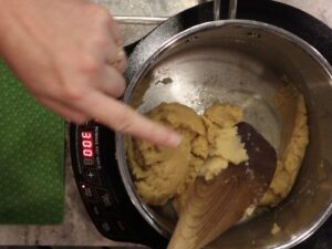 finger pointing and showing the dough is steaming