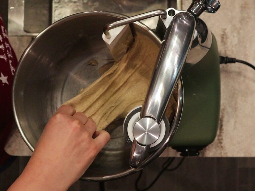 hand stretching the dough to make sure it is ready