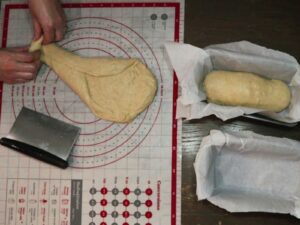shaping the sourdough sandwich bread dough into loaves