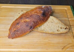 Fresh milled flour sourdough baguettes sliced in half longwise to show the interior crumb