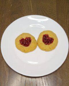 Valentine heart Thumbprint cookies made with fresh milled flour and homemade raspberry jam