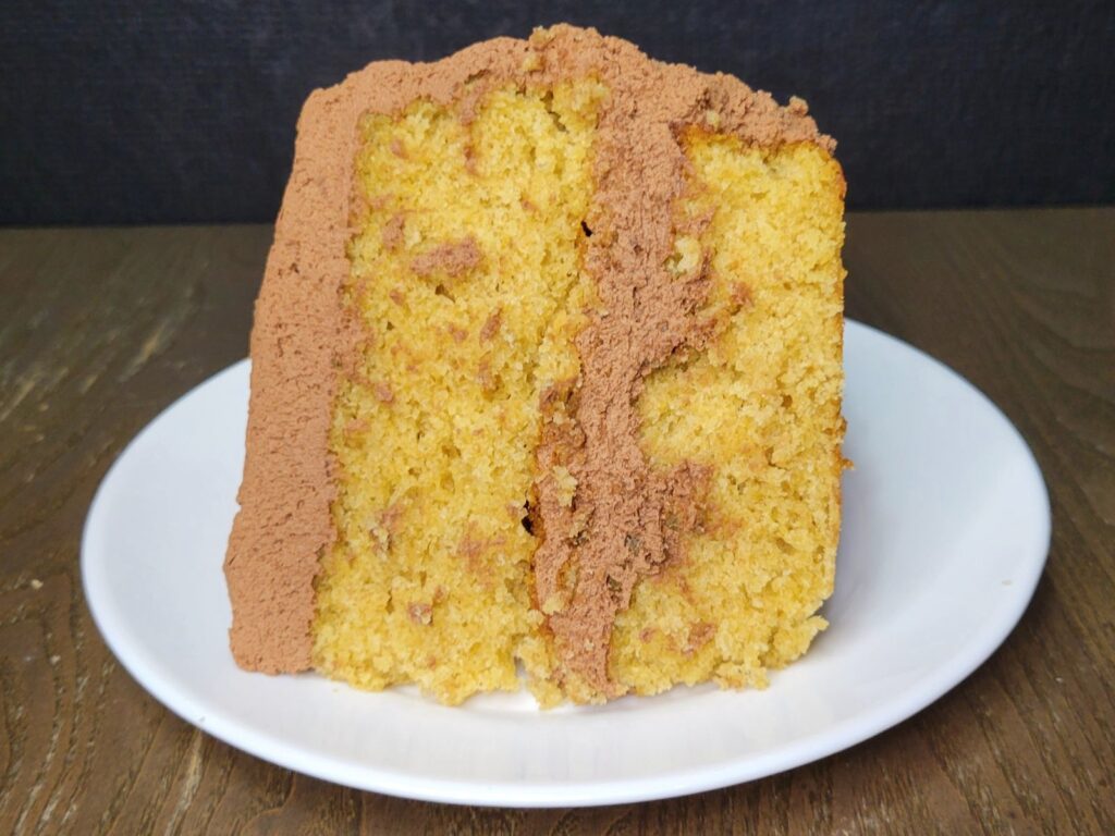fresh milled flour yellow birthday cake slice with chocolate ganache buttercream