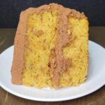 fresh milled flour yellow birthday cake slice with chocolate ganache buttercream