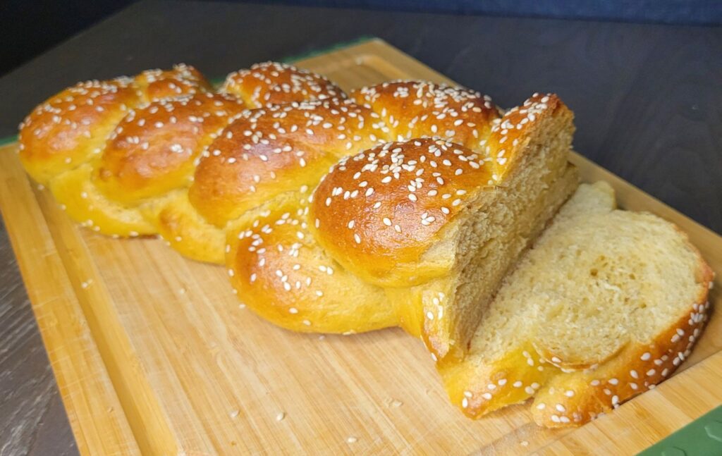 sliced fresh milled flour braided challah with sesame seeds