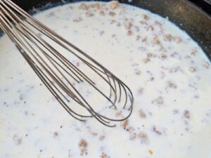 adding the milk and whisking