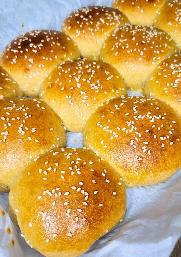 egg washed and sesame seed hamburger buns made with sourdough and fresh milled flour