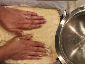 pressing the crust into the pan