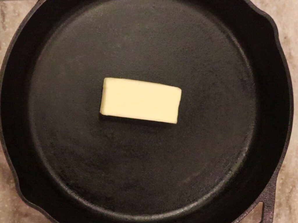 a stick of butter in a cast iron skillet