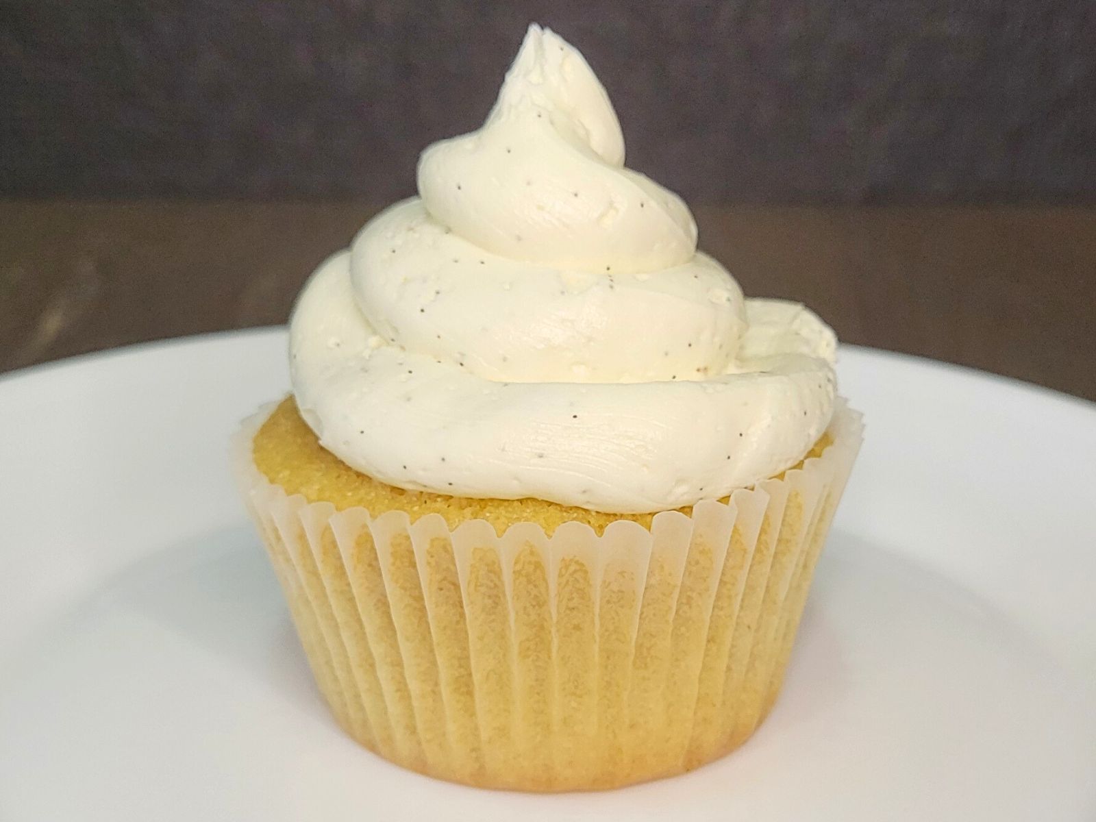 a vanilla cupcake made with fresh milled flour and topped with vanilla bean frosting