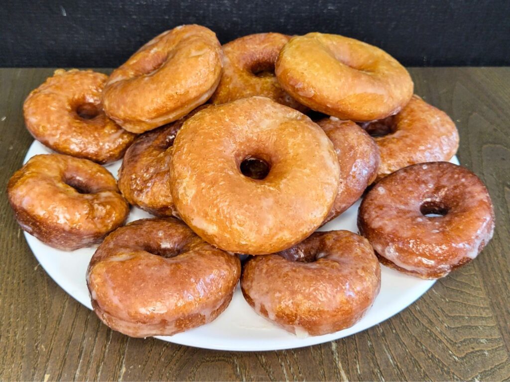 a plate full of yeast glazed donuts made with fresh milled flour