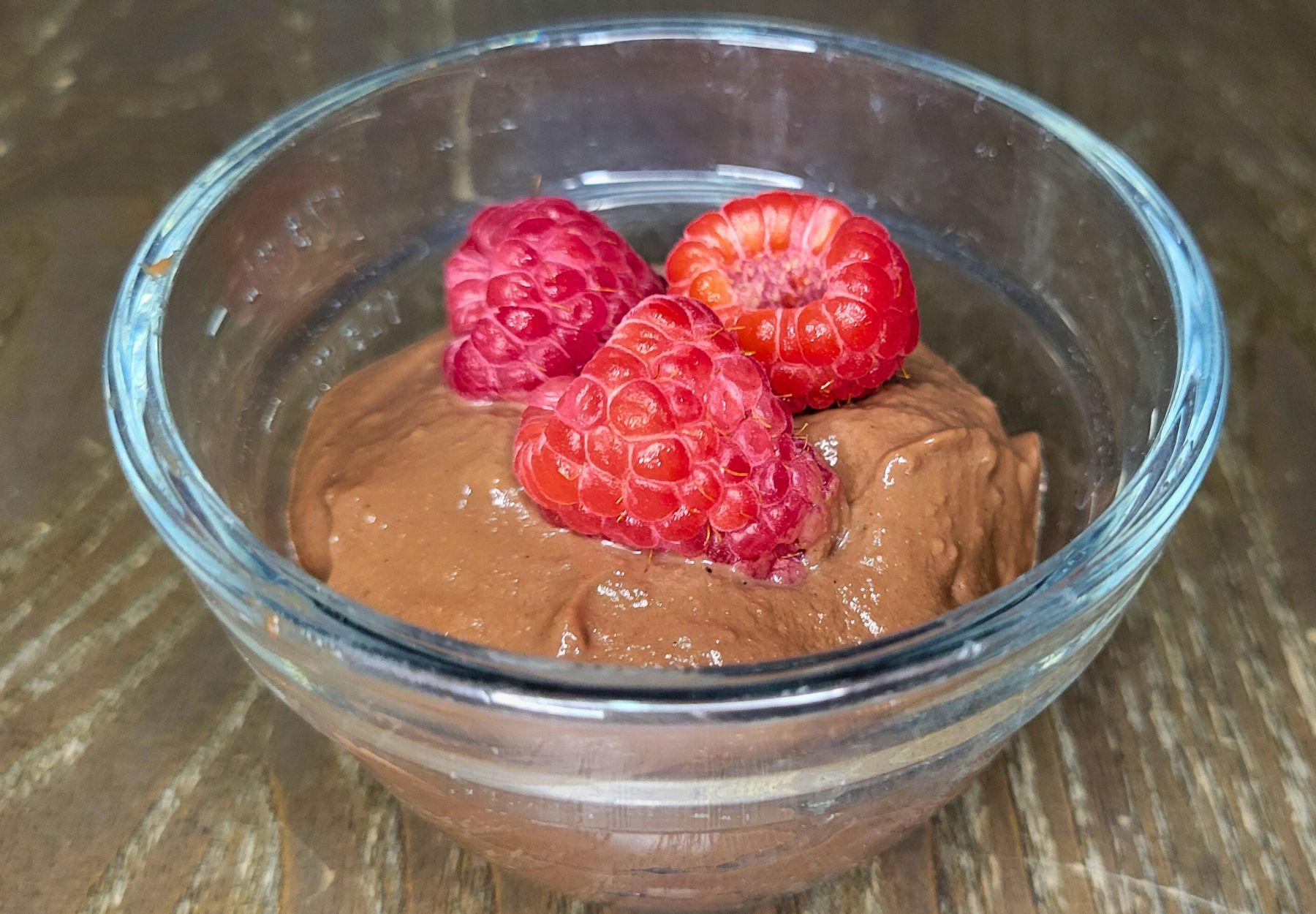 chocolate pudding made with fresh milled flour and topped with fresh raspberries