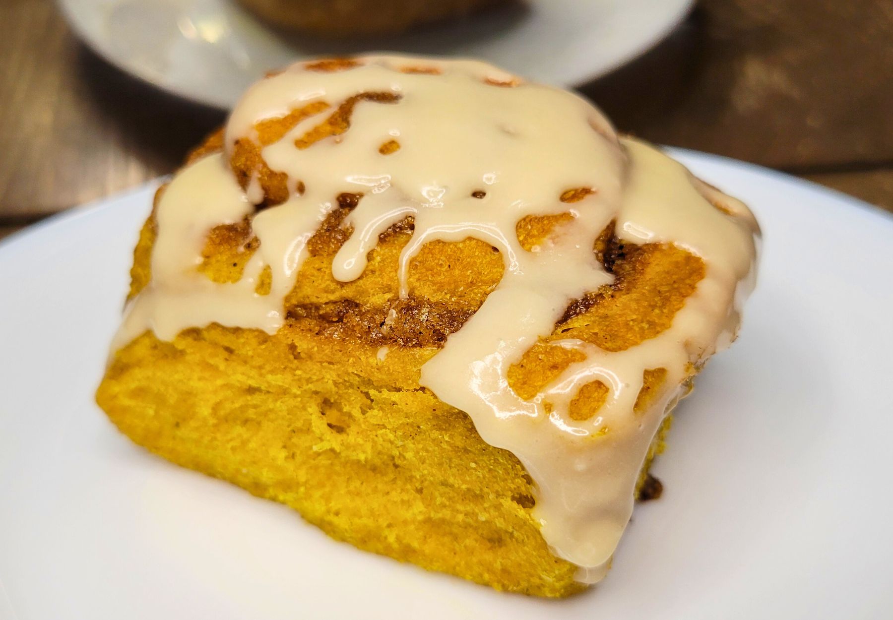 an iced fresh milled flour pumpkin cinnamon roll