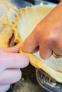 hands crimping the dough