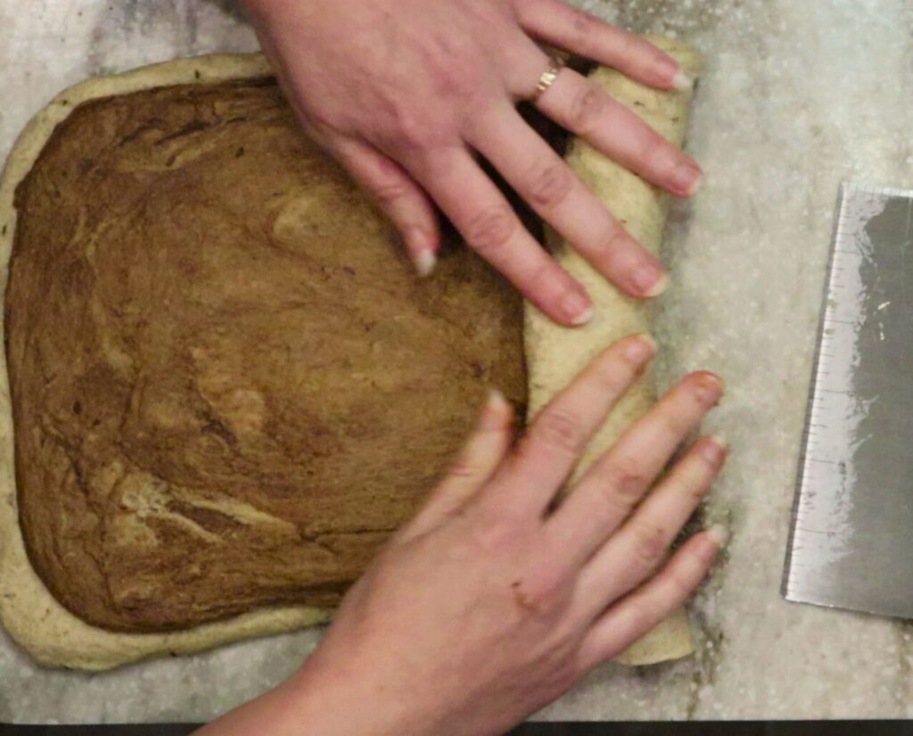 hands rolling up the fmf marbled rye dough