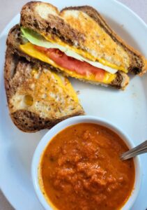 sandwich with rye bread and tomato bisque soup