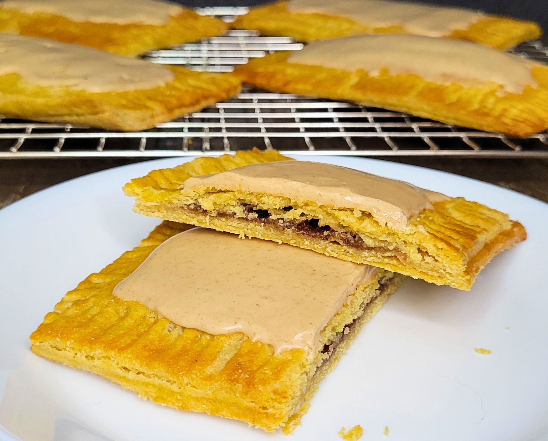 Fresh milled flour pop tarts cut in half showing the brown sugar cinnamon filling