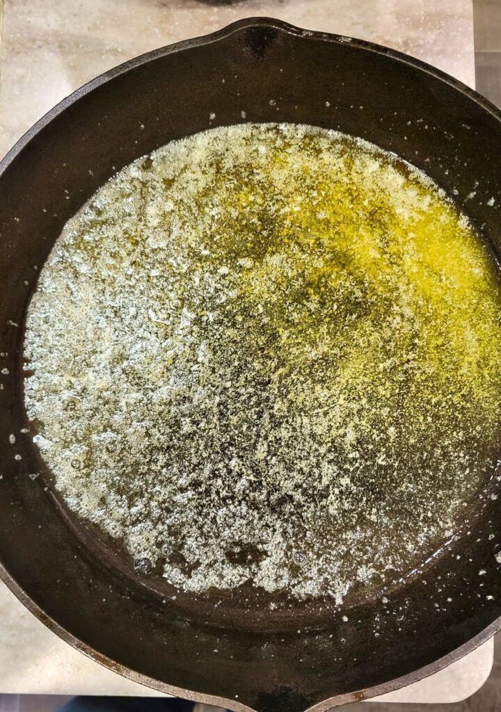 melt butter in the preheated cast iron skillet right before you pour the batter in