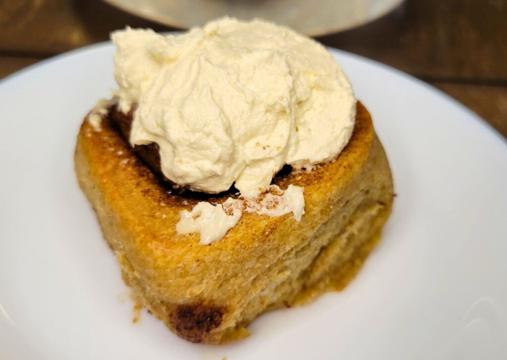 sourdough cinnamon rolls made with fresh milled flour topped with icing