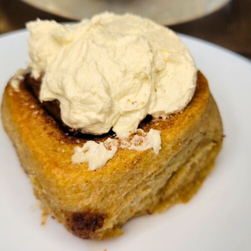 sourdough cinnamon rolls made with fresh milled flour topped with icing