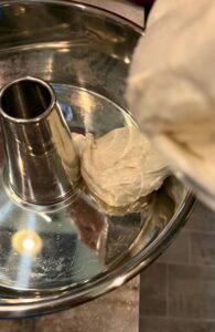 pouring the fresh milled flour angel food cake batter into the uncreased angel for cake pan