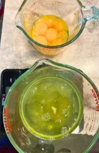 separating the egg yolks and egg whites into separate bowls