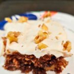 apple walnut cake slice made with fresh milled flour cream cheese frosting