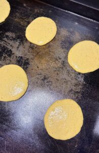 cooking the batter on a hot griddle