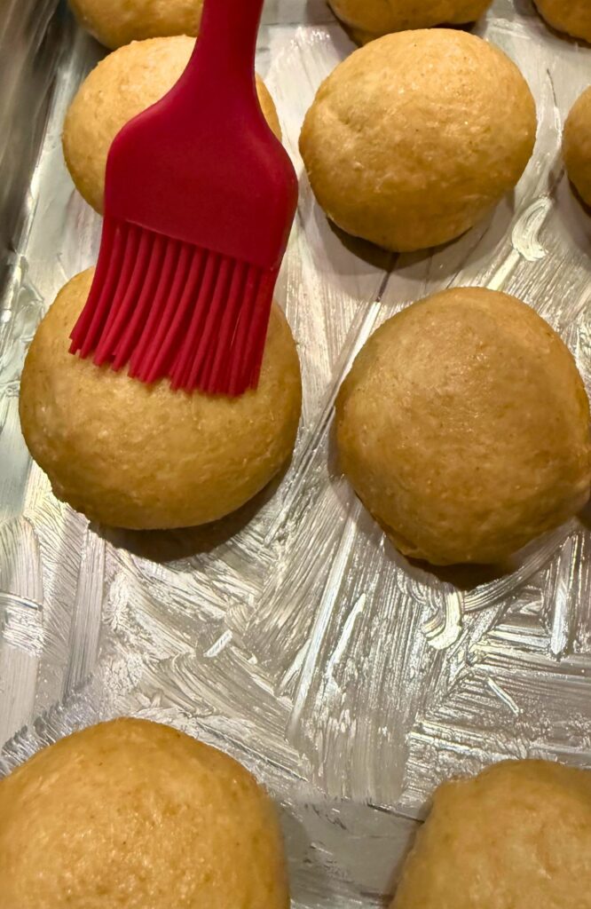 applying the egg wash on the dough