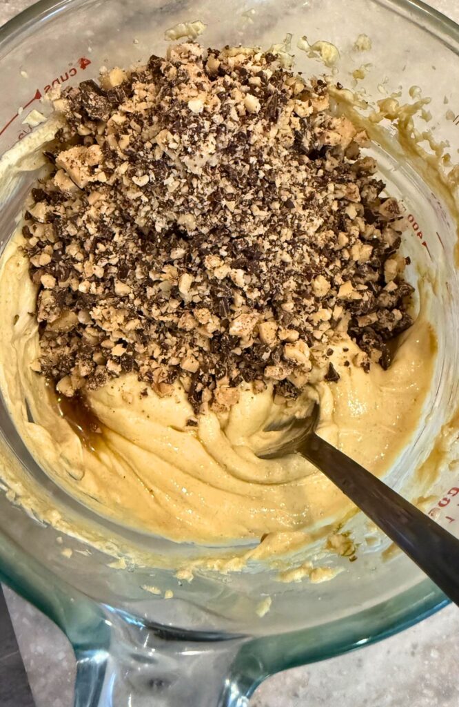 adding the toffee bits to the cream cheese apple dip