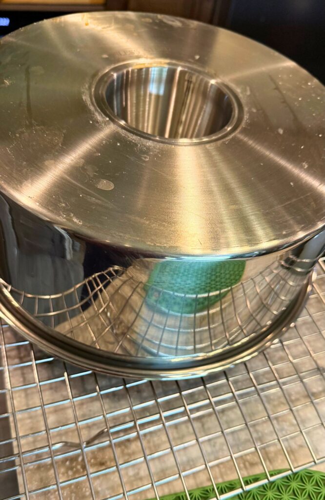 allowing the cake pan to cool upside down in the pan