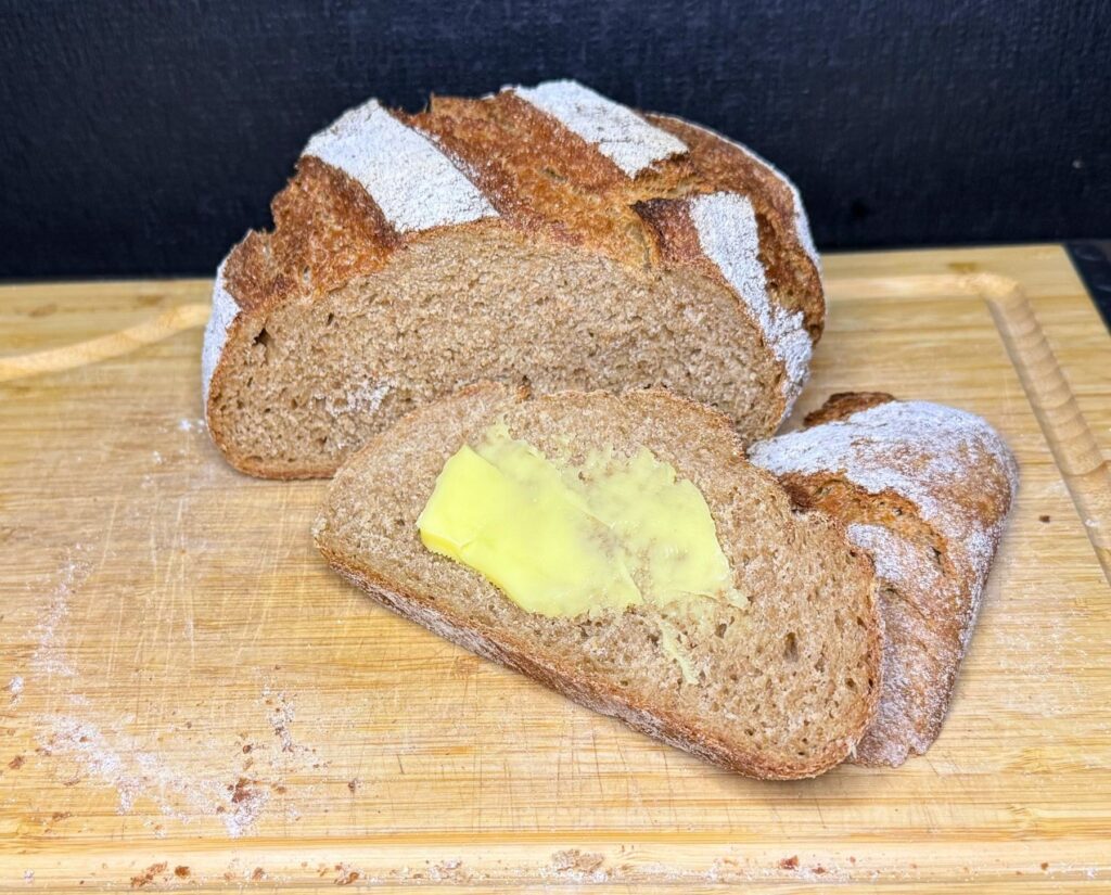 fresh milled flour crusty spelt bread sliced with butter